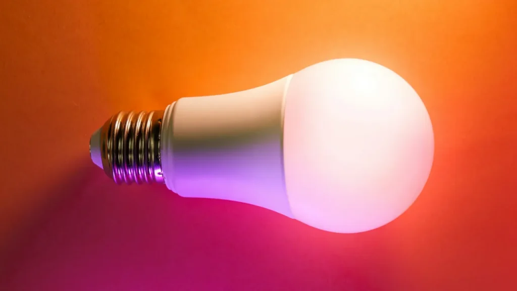 smart light bulb glowing with warm orange light to illustrate enclosed overheating.