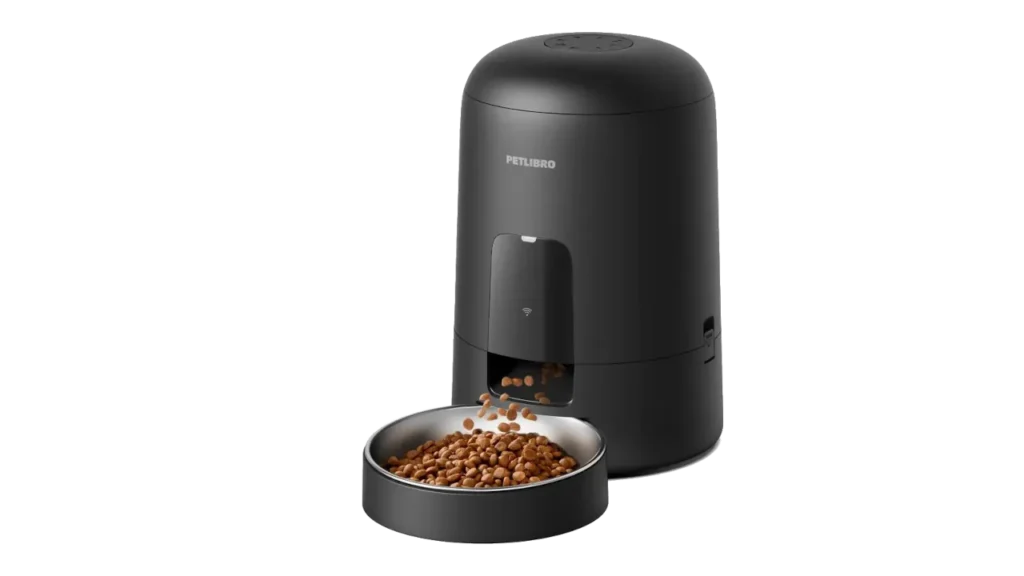 Black PetLibro Air WiFi smart feeder dispensing dry cat kibble into a stainless steel bowl.