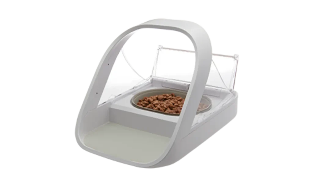 White SureFeed Microchip Pet Feeder Connect with its clear motorized lid open over a bowl of kibble.