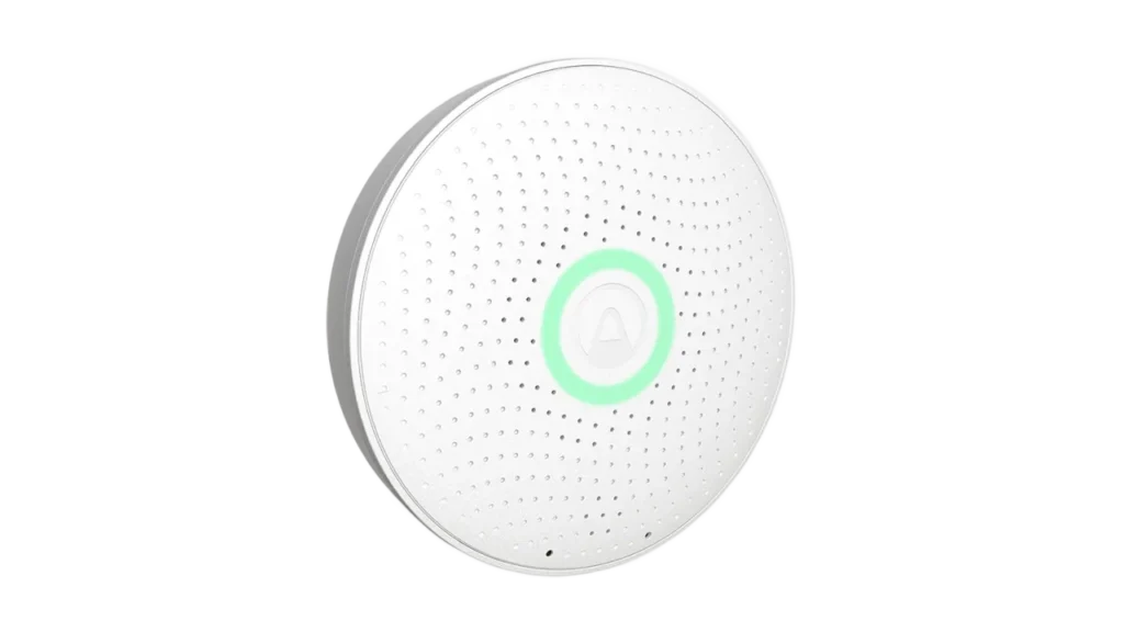 Airthings Wave Plus CO2 monitor, a round white sensor with a glowing green activation ring.