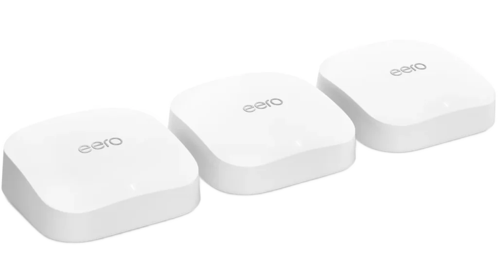 Three white eero Pro 6E mesh Wi-Fi routers sitting on blue tiered display steps.