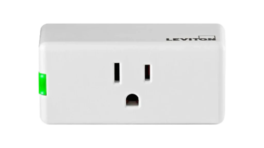 White Leviton Decora smart mini plug with a green side button and front socket.