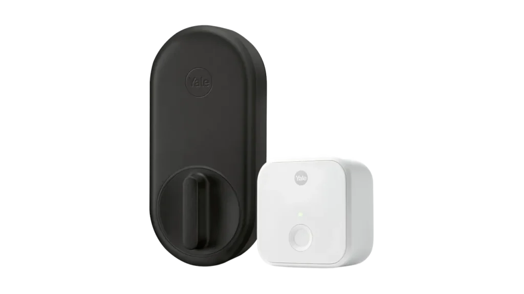 Black Yale Approach smart lock interior unit alongside a white plug-in Wi-Fi bridge.