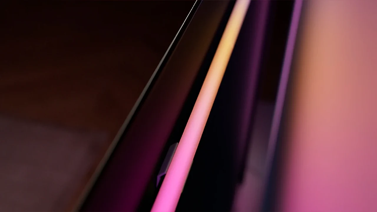 Hue Play gradient light strip glowing pink and orange behind a TV