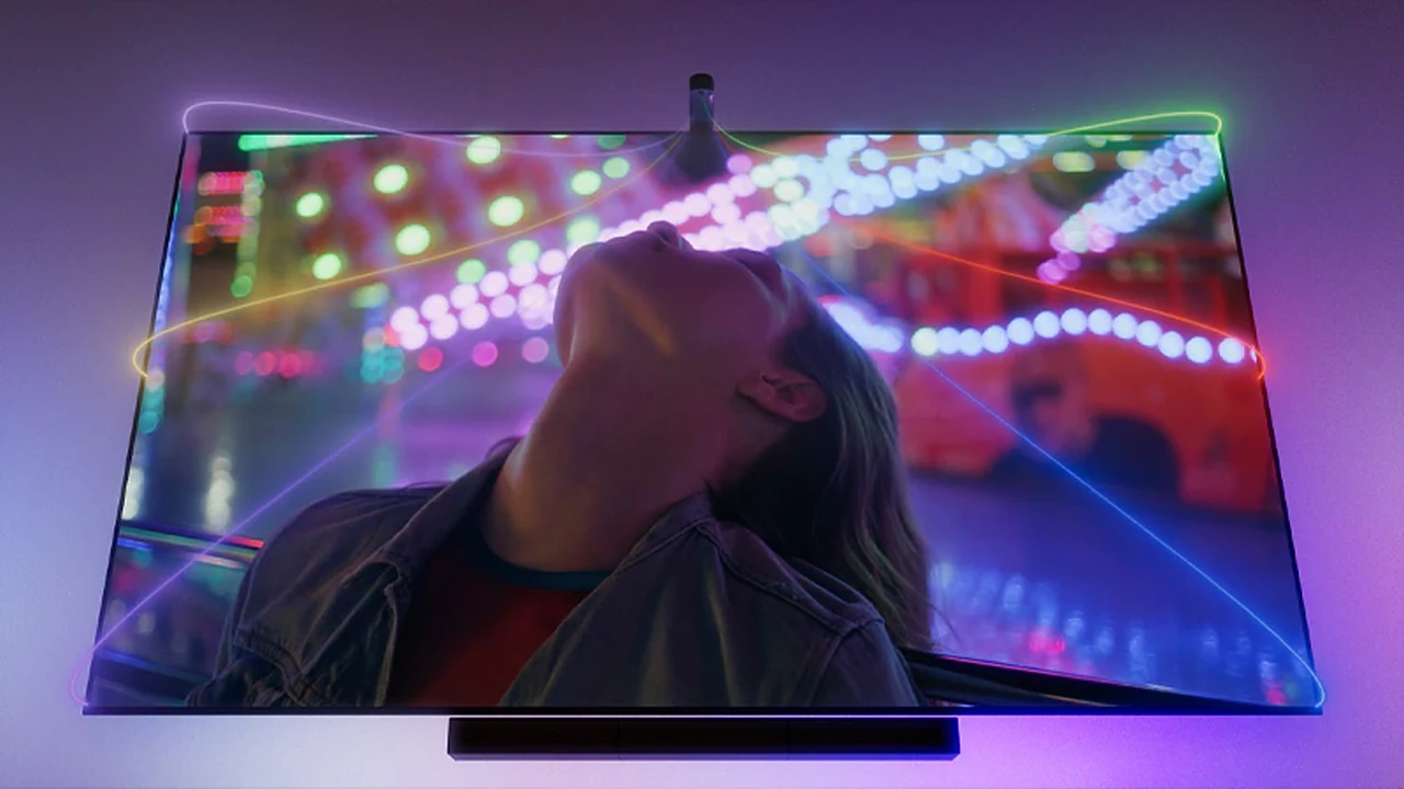 TV showing a colorful carnival scene with Hue lights matching the colors around the screen